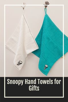 two teal towels hanging on a clothes line with the words snoopy hand towels for gifts