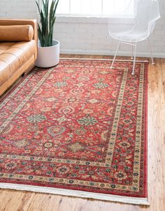 a living room area with a couch, chair and rug