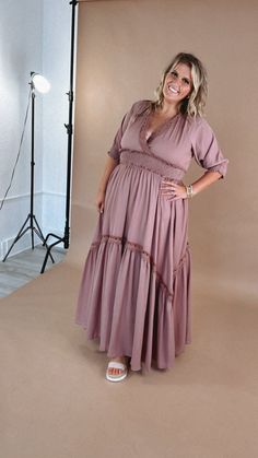 a woman standing in front of a photo studio