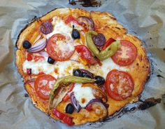 a pizza sitting on top of a pan covered in cheese and veggie toppings