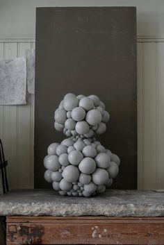 a sculpture made out of balls on top of a table