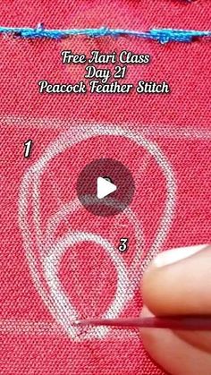 someone is stitching on the back of a piece of red fabric with a needle