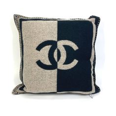 a black and white pillow with the letter g on it