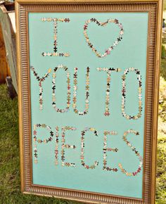 a framed sign that says i love you to the side with beads and hearts on it