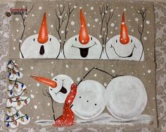 three snowmen with orange hats and trees in the background