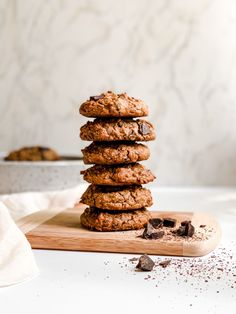 a stack of cookies sitting on top of a wooden cutting board