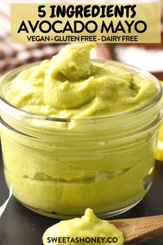 a jar filled with avocado mayo next to a wooden spoon