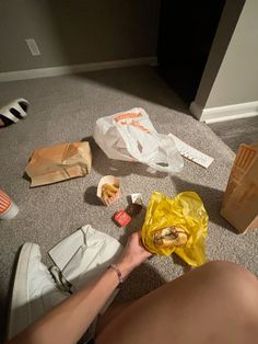 a person is sitting on the floor with food