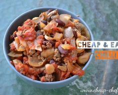 a bowl filled with meat and vegetables on top of a glass tablecloth that says cheap & easy