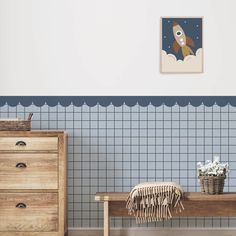 a room with blue and white wallpaper, a wooden bench and two baskets on the floor