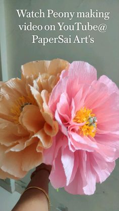 two paper flowers are held up by someone's hand with the words watch peony making video on youtube / youtube @ papersai arts