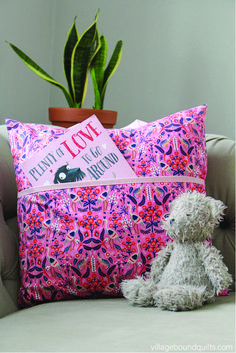 a stuffed animal sitting on top of a couch next to a pillow