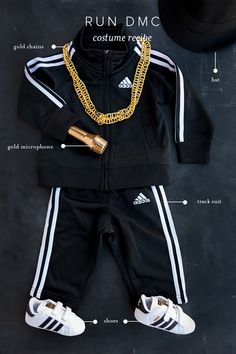 a black and white outfit with gold chains on it, including a baseball cap, adidas sneakers, and a hat