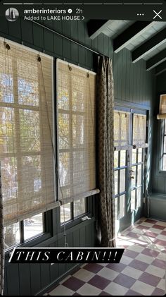 the window shades are closed in front of an open door with checkered flooring