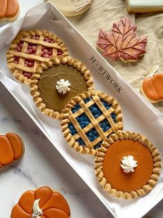 some pumpkin pies and cookies on a table