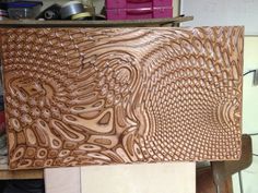 a wooden cutting board sitting on top of a workbench in a workshop area