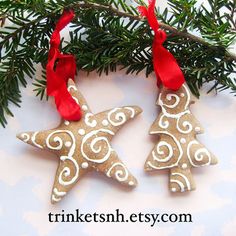 two christmas ornaments hanging from a tree branch