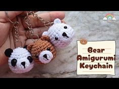 two small crocheted bears are being held by someone's hand with the words bear amigurum keychain