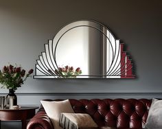 a living room filled with furniture and a large mirror on the wall above it's headboard