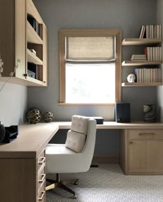 a home office with a desk, chair and bookshelf in the corner by the window