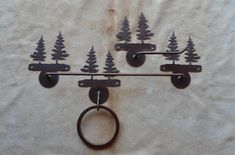 there are three metal hooks with trees on them