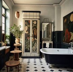 an ornate bathroom with black and white tile flooring, antique furniture, and paintings on the walls