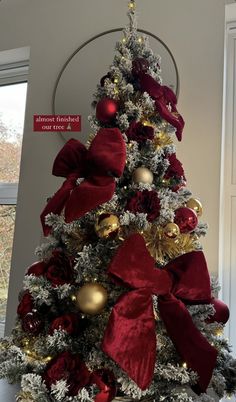 a decorated christmas tree with red and gold ornaments