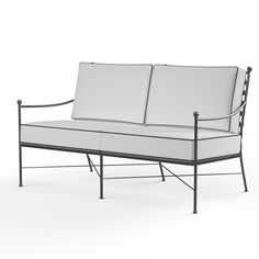 a white couch sitting on top of a metal frame