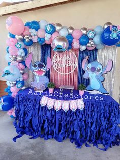 the balloon arch is decorated with blue, pink and silver balloons for an elephant themed birthday party