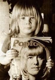 two children are holding up posters with the word pop to them in front of their faces