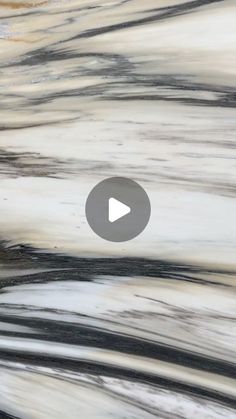 an abstract painting with black, white and grey streaks on it's surface is featured in the video