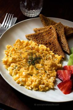 an omelet with toast, watermelon and strawberries on a plate