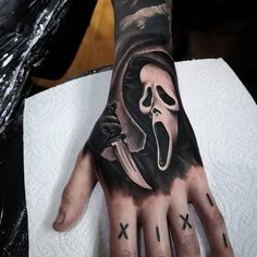 a person's hand with a tattoo on it