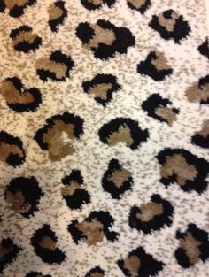 an animal print rug with black and brown spots