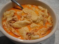 a white bowl filled with food on top of a table