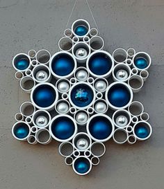 an ornament hanging on the side of a wall with blue ornaments in it