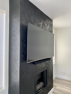 a flat screen tv mounted to the side of a fireplace