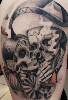 a woman with a hat and skull tattoo on her back