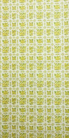 a yellow and white wallpaper with small green leaves on the bottom half of it