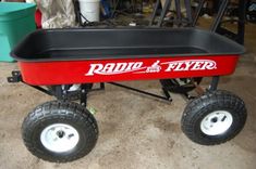 the radio flyer wagon is red and black with white spokes on it's wheels