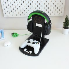 a game controller and headphones sitting on top of a desk