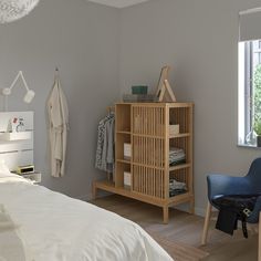 a bed room with a neatly made bed and a wooden shelf next to the bed