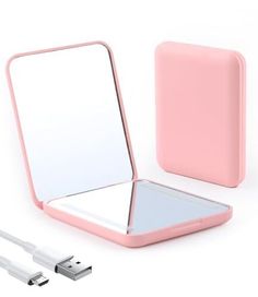 a pink portable mirror and charger next to an apple iphone 5g charging cable