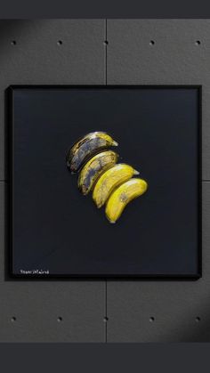 a bunch of bananas sitting on top of a black table next to a gray wall