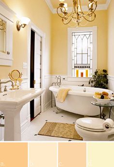 a bathroom with yellow walls and white fixtures