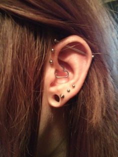 an ear with two piercings attached to it