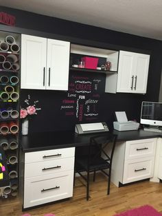 a home office with chalkboard on the wall and lots of storage space in it