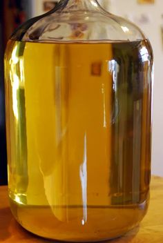 a glass jar filled with liquid sitting on top of a table