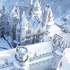 an aerial view of a castle in the snow