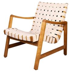 a wooden chair with white and black stripes on it's armrests, sitting in front of a white background